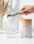 Pura Collagen glow+ bottle with glowing label, showcasing the collagen supplement for skin health and radiance.