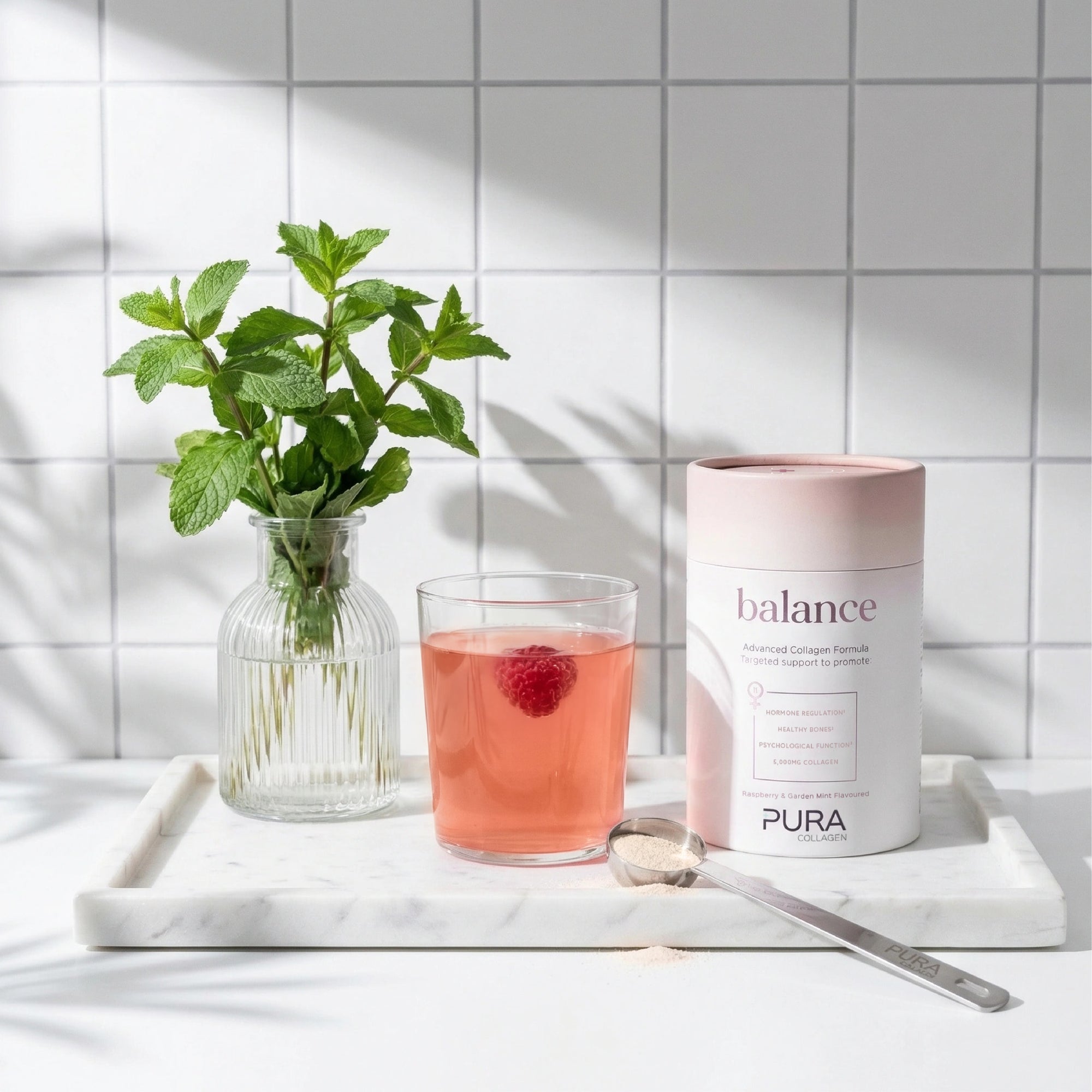 Pura Collagen Balance supplement container with label showing product name and health benefits, placed on a clean white background.